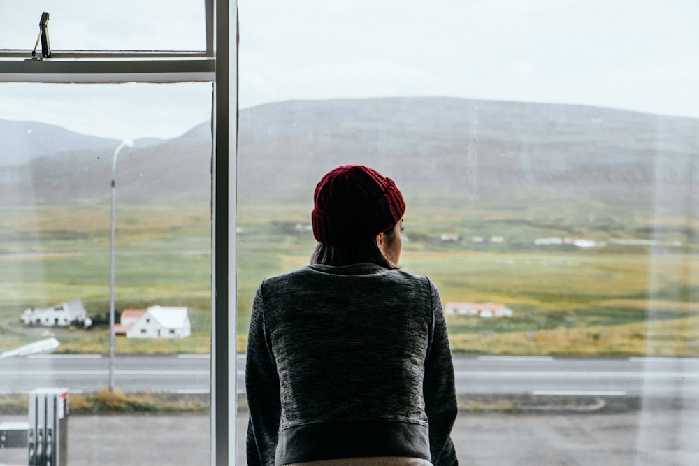 woman standing on glass window