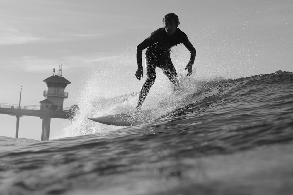 man surfing under gray sky