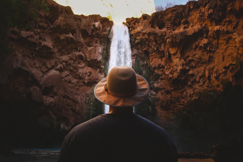person facing waterfalls