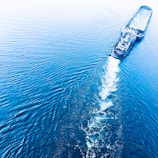 Aerial view of a modern cargo ship navigating through calm waters.
