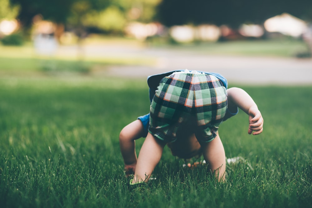 toddler on grass field