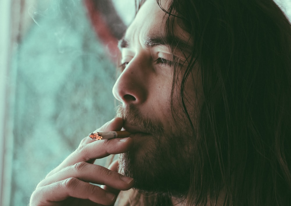 man smoking red cigarette