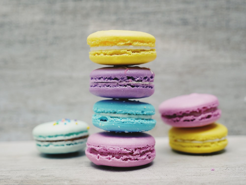 four macarons balancing near two and one macarons