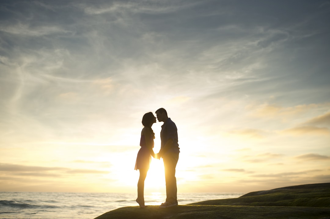 silhouette of man and woman about to kiss, The Kiss