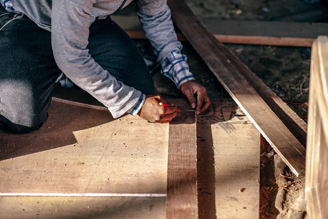 A contractor working on a wooden deck in Pokhara