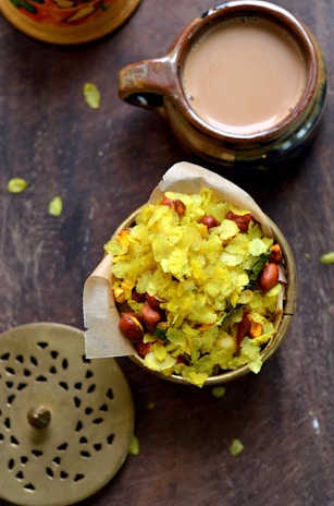 Close-up of a delicious, crispy snack plate with a cup of steaming tea beside it.