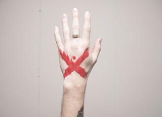 left human hand with x mark