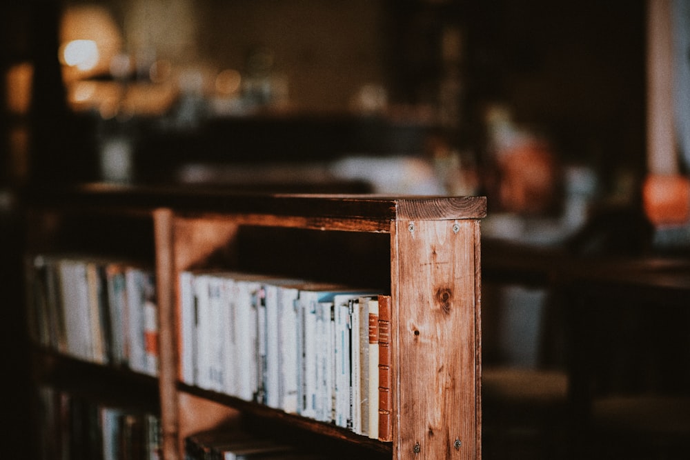 brown wooden book shelf with books