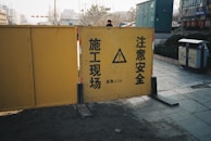 Protective barriers and safety signs around a road pest control operation.
