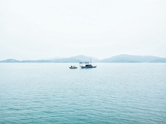 two white boats in middle of sea during daytime in Tianmu Lake China