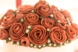 A close-up of a wedding cake topped with fresh blooms.