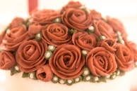 A close-up of intricate air-painted designs on a wedding cake.