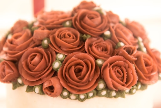 Close-up of a beautifully decorated custom cake with delicate floral details.