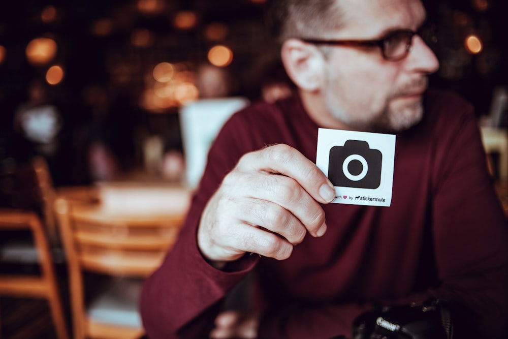 man walking a card with camera icon