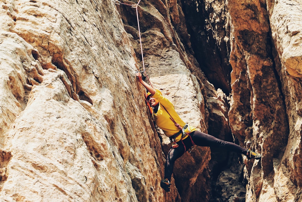 person climbing on the rock