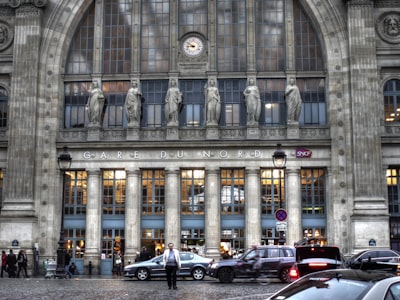 man walking crossing street in front of building classicism google meet background