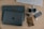 A close-up of a laptop and various electronic accessories on a clean workspace.