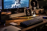 black corded gaming computer keyboard and flat screen monitor