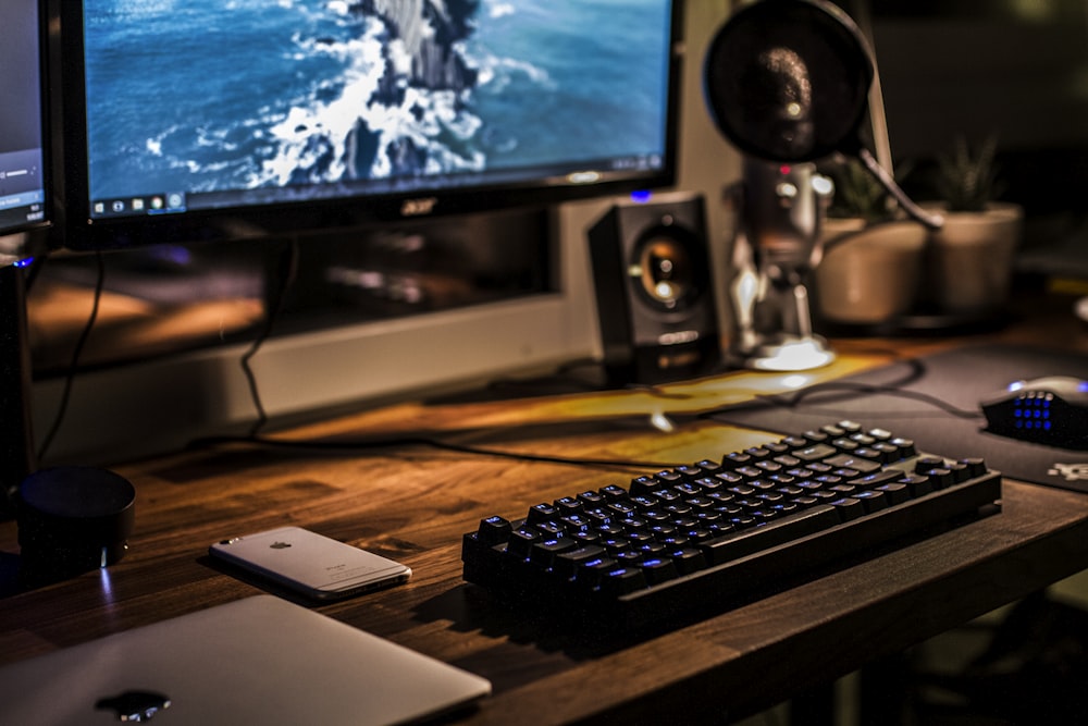 black corded gaming computer keyboard and flat screen monitor