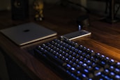 A modern, minimalist desk setup with astral-themed lighting and technology gadgets.