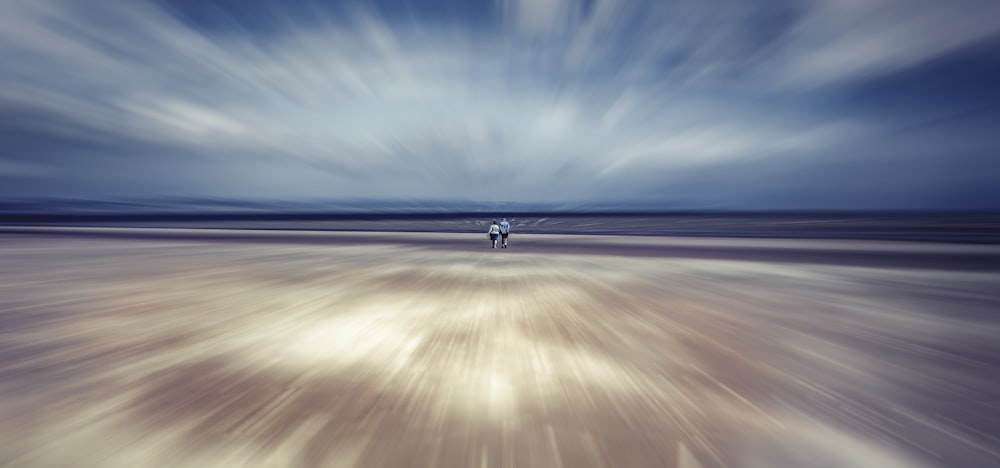 view of couple walk at the beach