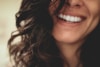 long black haired woman smiling close-up photography