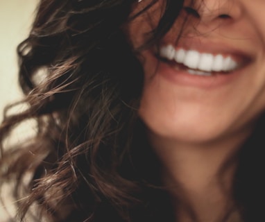 long black haired woman smiling close-up photography