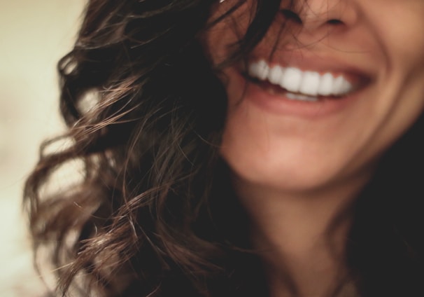 long black haired woman smiling close-up photography