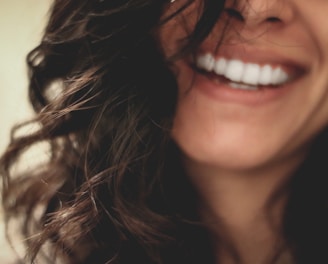 long black haired woman smiling close-up photography