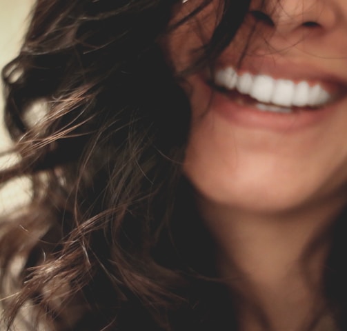 long black haired woman smiling close-up photography