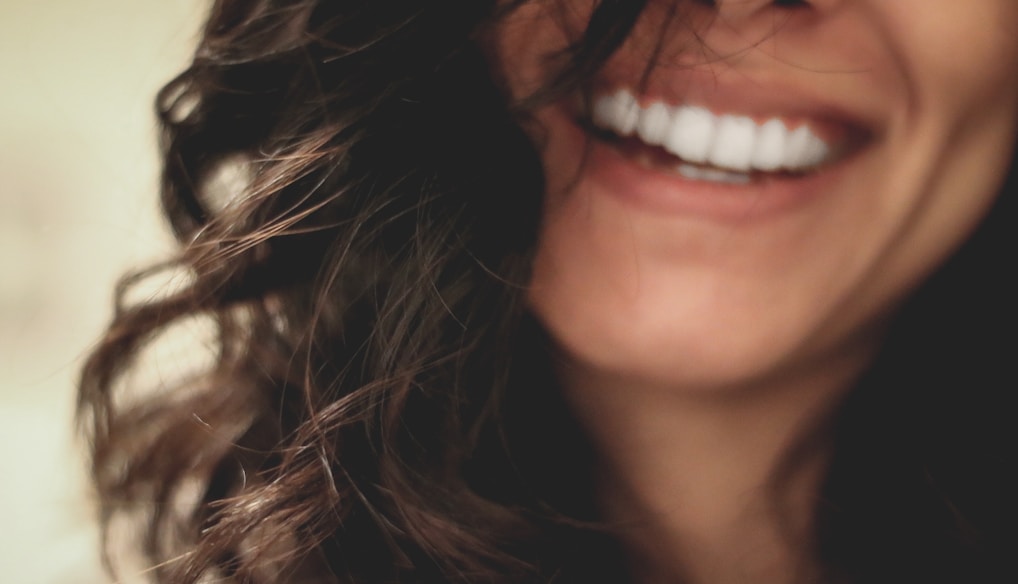 long black haired woman smiling close-up photography