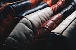 A diverse collection of leather jackets displayed on hangers.