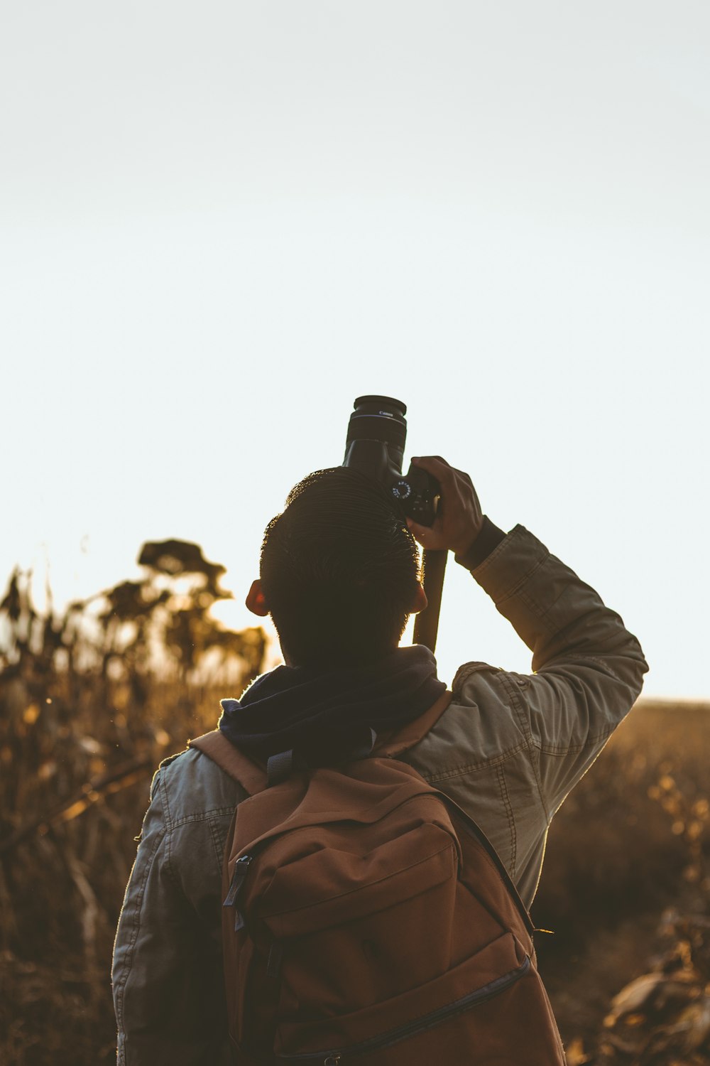 man taking picture using DSLR camera