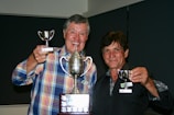 A vibrant celebration of winners holding their trophies.