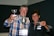 A group of happy padel players celebrating a victory with their trophies in hand.