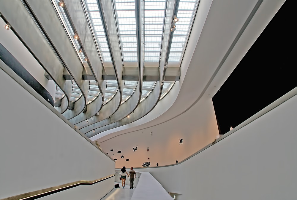 man and woman walking inside building