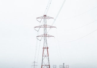 red electric tower surrounded by trees