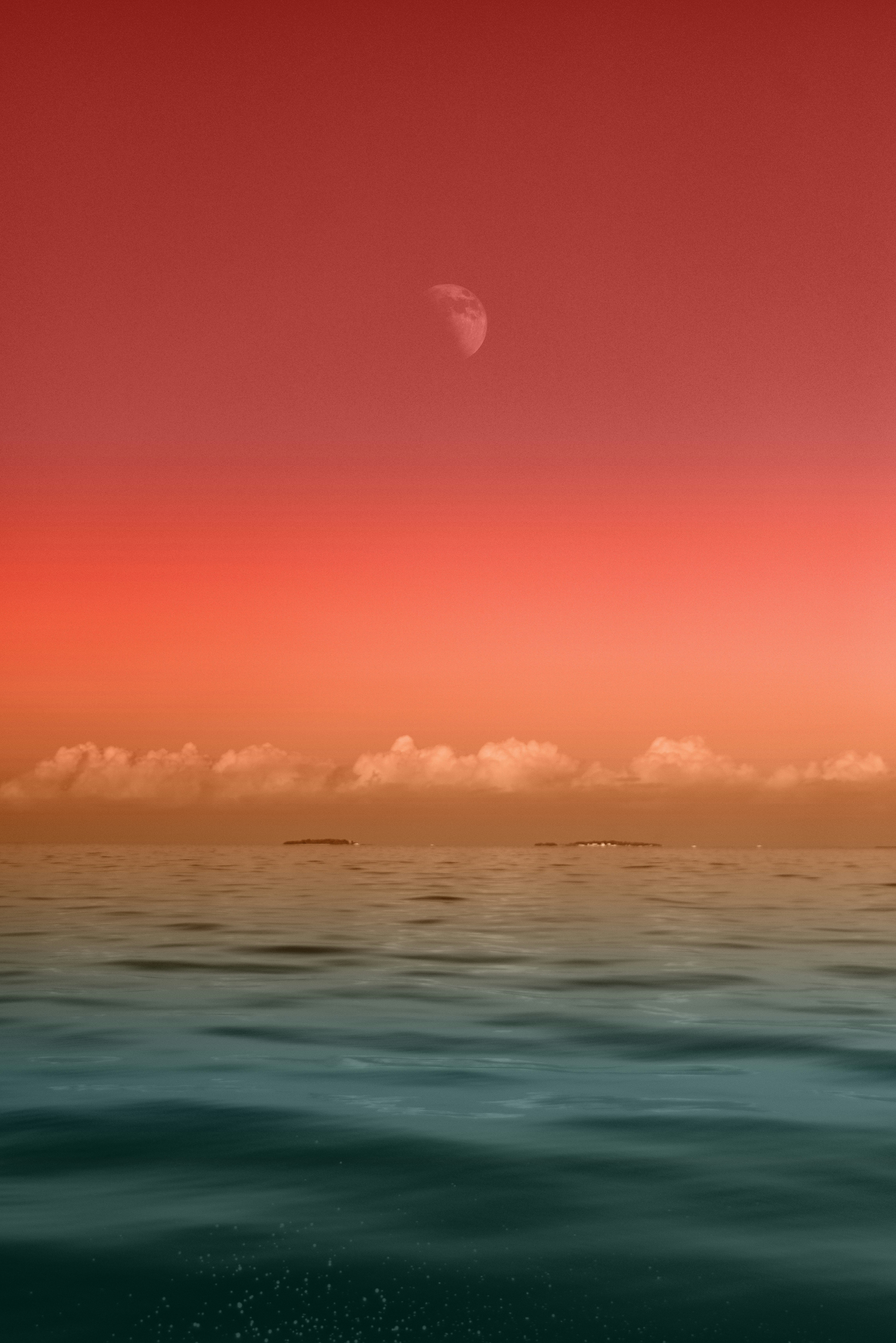 seascape photography of sea under half-moon