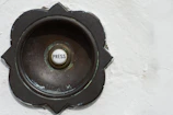 Dimansi doorbell in use, with a visitor pressing the button, framed by clean architectural lines and subtle shadows.