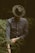 shallow focus photography of man standing while folding his sleeve