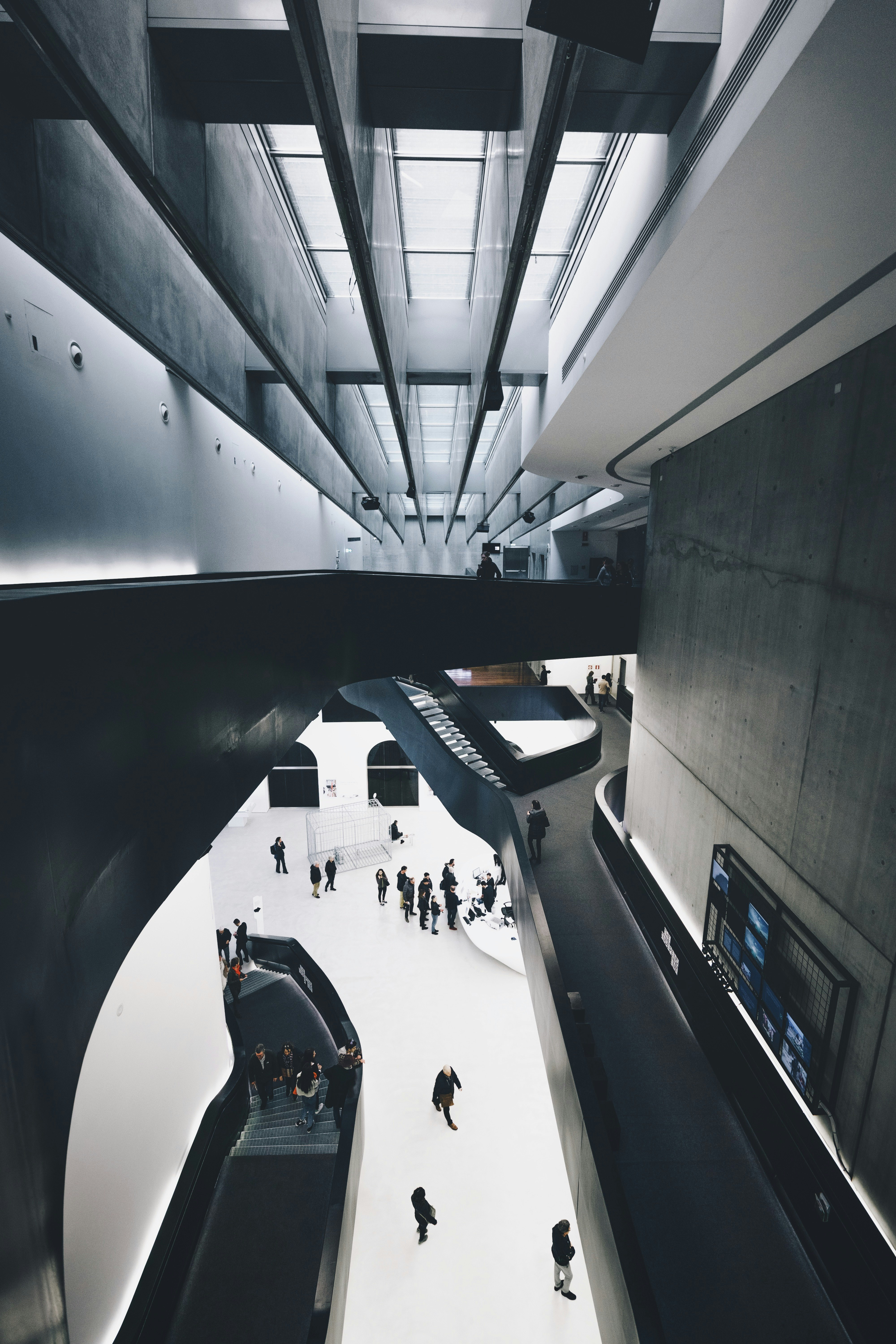 people in suit walking inside a building