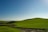 A serene landscape with soft hills and a calm sky, symbolizing peace and healing.