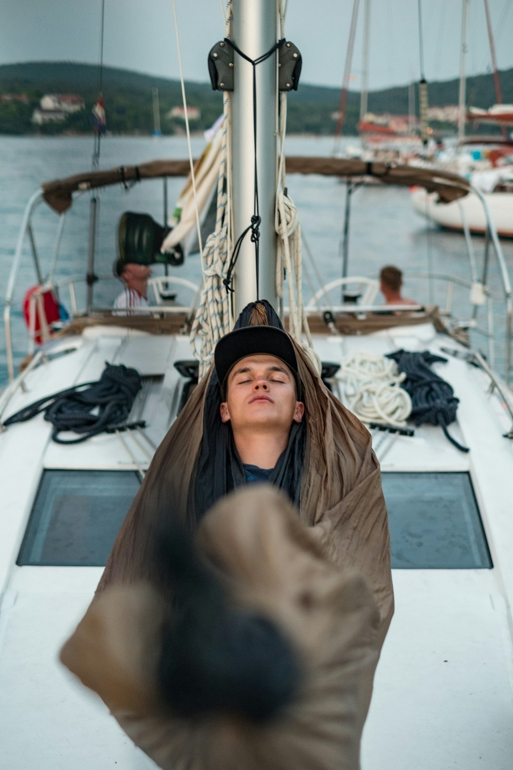 man sleeping on boat hammock