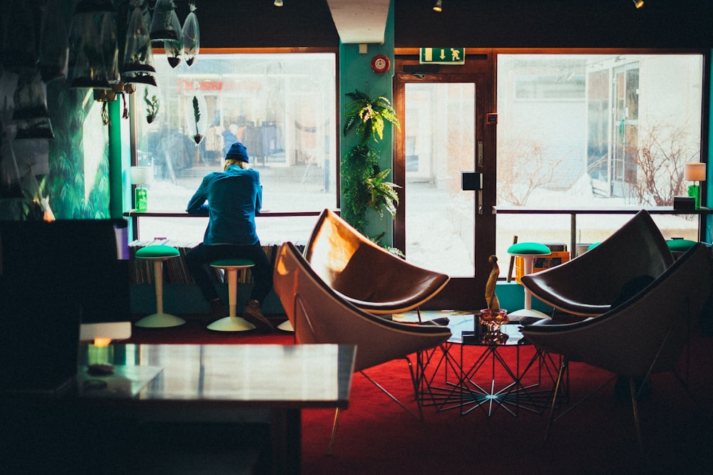 person sitting while facing window