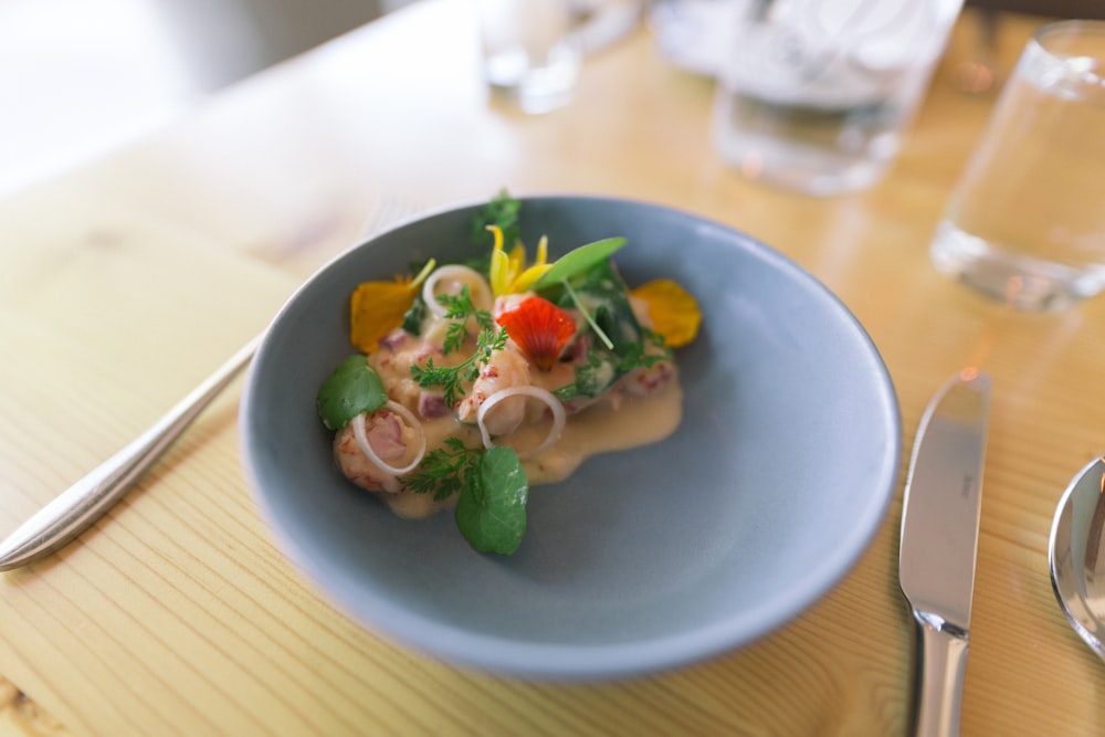 vegetable salad on blue ceramic bowl