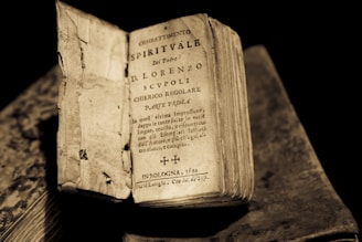 An ancient Italian book of spells open with handwritten notes.