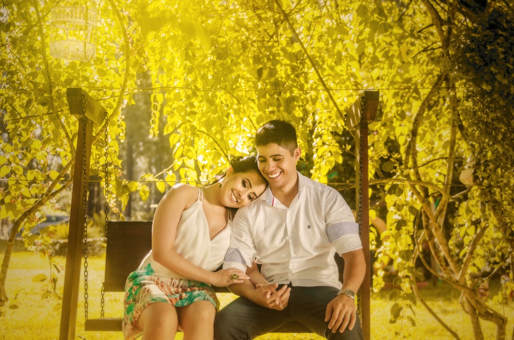 man and woman sitting on bench