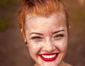 woman taking photo while showing smile