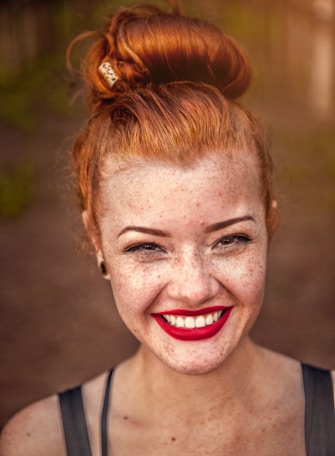 woman taking photo while showing smile