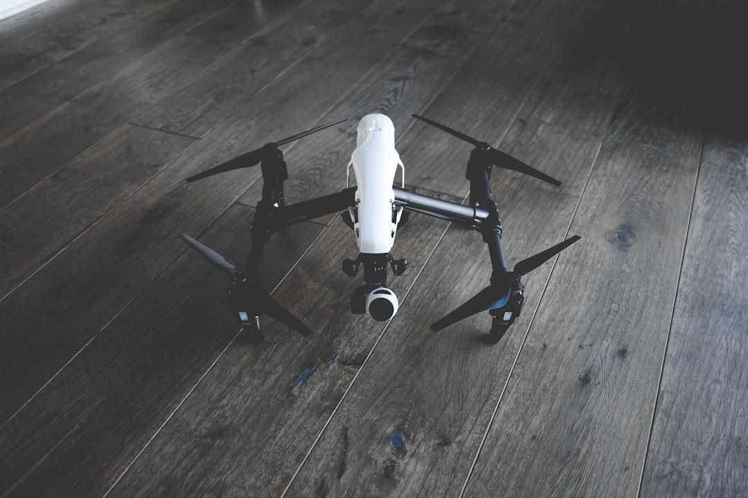 white and black quadcopter drone